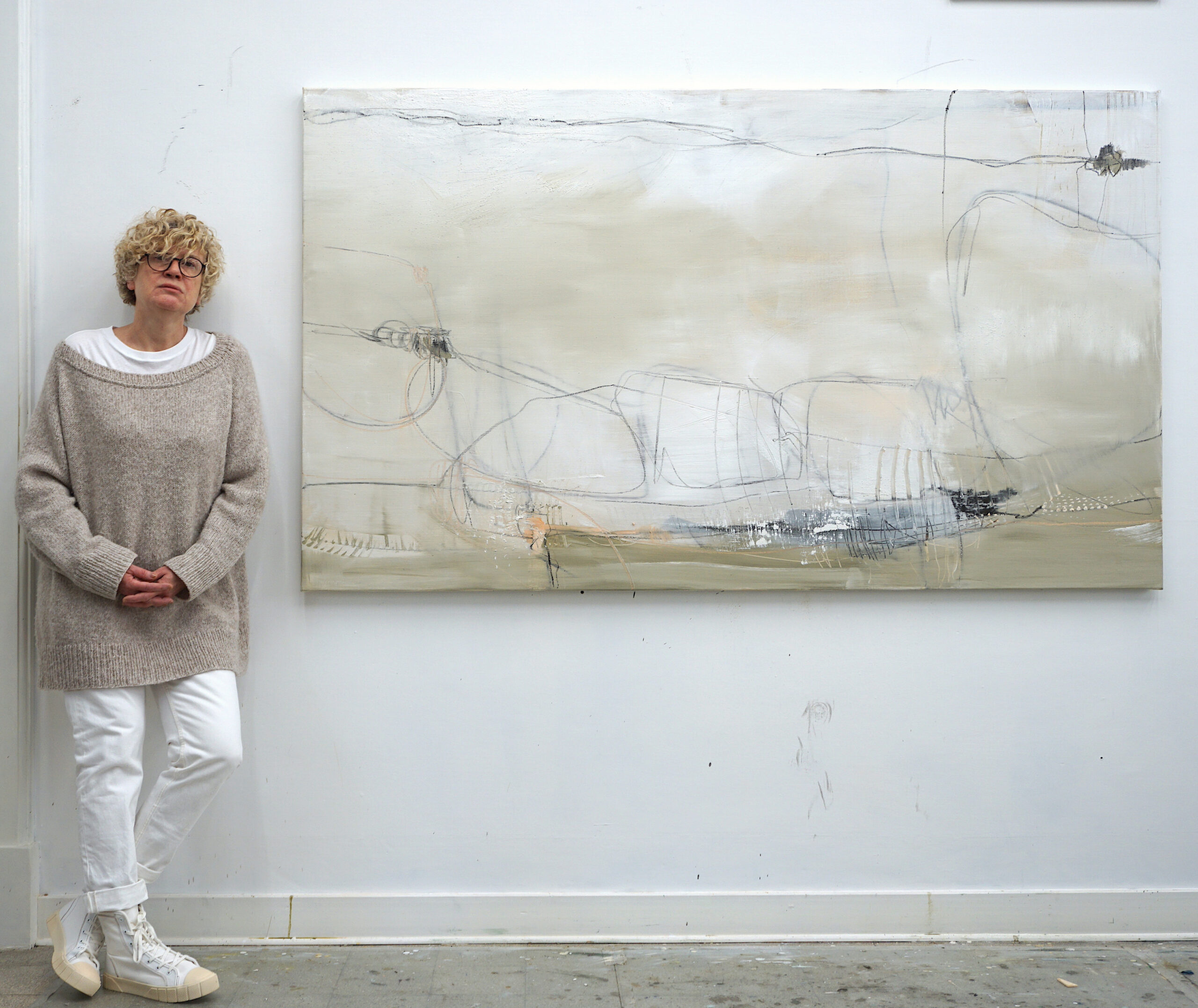 Larissa Eremeeva standing next to a large abstract expressionist painting